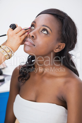 makeup artist applying eyeliner