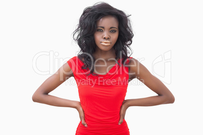 Woman standing wearing a red dress hands in hips