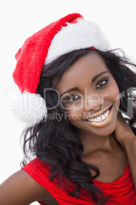 Woman wearing red dress and Santa Claus hat