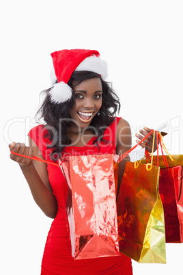 Woman holding bags while smiling