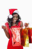 Woman holding bags while smiling