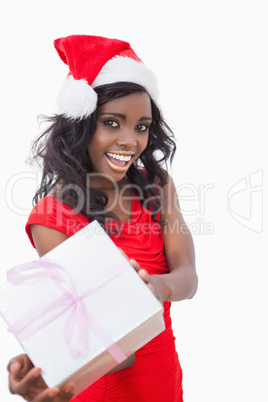 Festive woman standing holding a gift