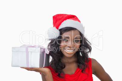 Woman standing holding a Christmas present