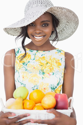 Woman standing holding a fruit basket