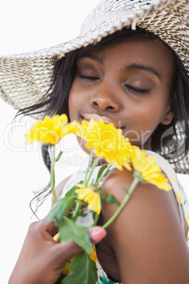 Woman smelling yellow flowers