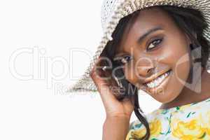 Woman smiling while wearing a summer hat