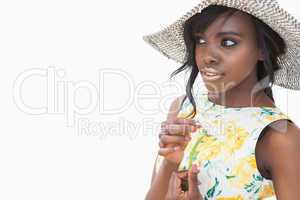 Woman wearing summer hat and holding daisy