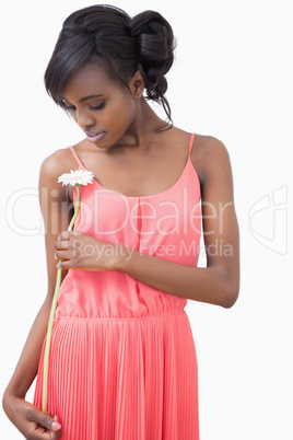 Woman standing holding a flower