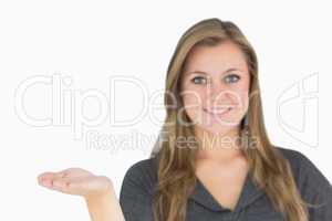 Blonde woman presenting with her hand