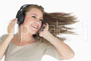 Smiling woman dancing with a headphone