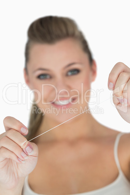 Woman holding dental floss