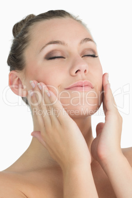 Blonde woman touching her face