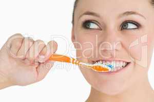 Cute woman washing her teeth