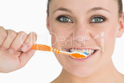 Happy woman washing her teeth