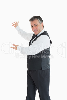 Smiling waiter showing us something