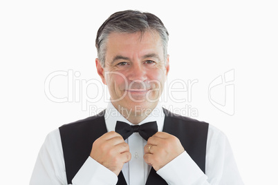 Waiter adjusting his own bow tie