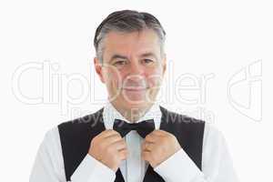Waiter adjusting his own bow tie