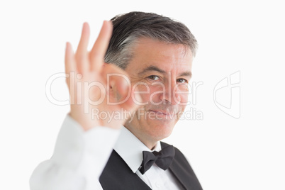 Well-dressed waiter making ok sign