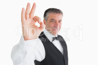 Happy waiter making OK sign