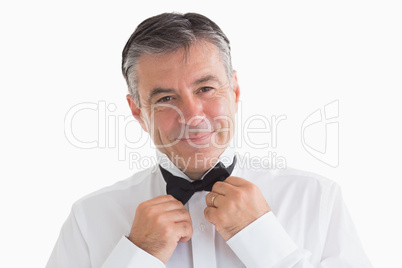 Well-dressed man adjusting his bow tie