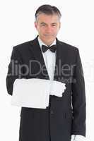 Smiling waiter holding a towel