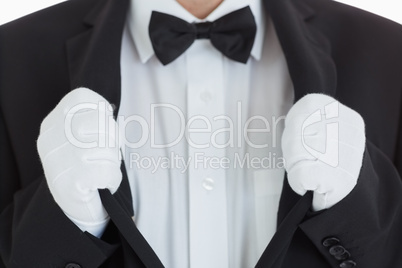 Well-dressed waiter clinging at his jacket