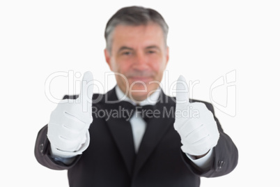 Pleased waiter having thumbs up