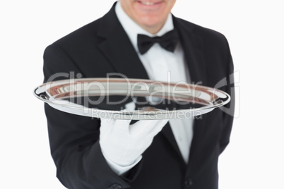 Smiling man holding a silver tray