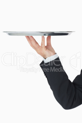 Well-dressed man holding silver tray