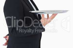 Waiter standing and holding a silver tray