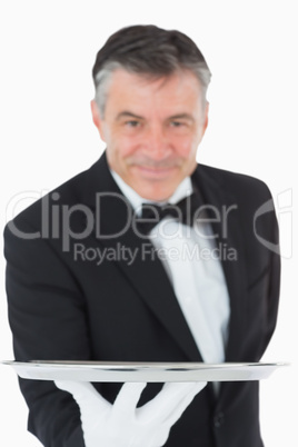 Waiter holding a silver tray out