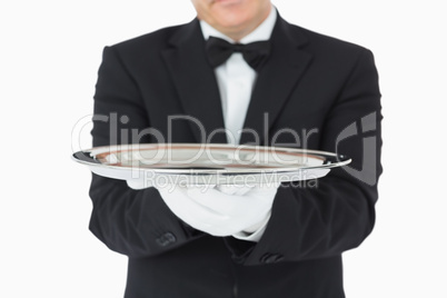 Man holding a silver tray with both hands