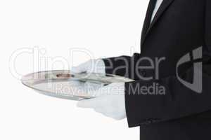 Man in suit holding silver tray
