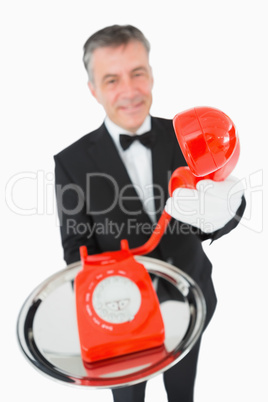 Waiter giving the phone to someone