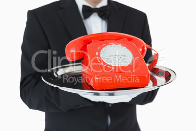Red dial phone on a silver tray