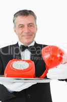 Waiter passing the phone receiver