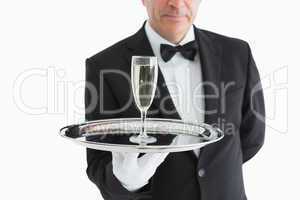 Man in suit serving glass with champagne
