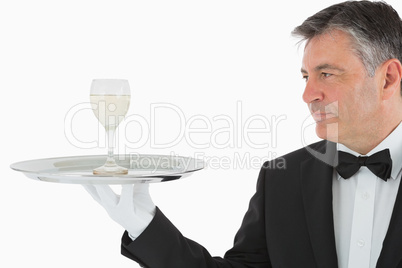 Man serving glass of wine on tray