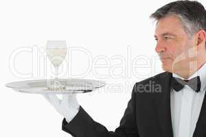 Man serving glass of wine on tray