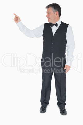 Waiter in suit pointing to something