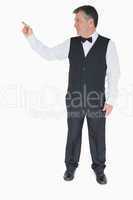 Waiter in suit pointing to something
