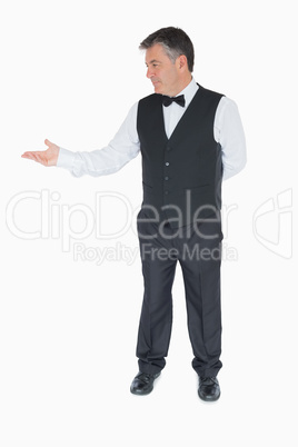 Waiter presenting something to the left