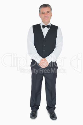 Happy waiter in uniform