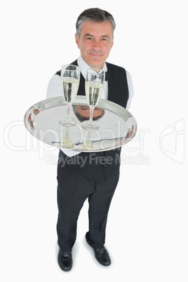 Waiter serving glasses of champagne