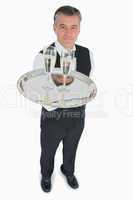 Waiter serving glasses of champagne