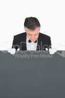 Waiter looking at board before him