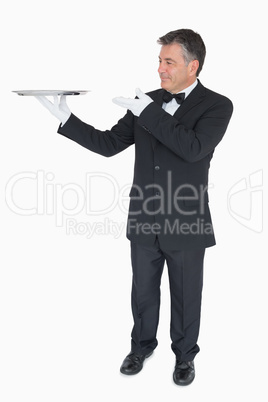Waiter presenting empty tray Waiter presenting empty tray