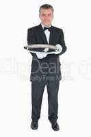 Waiter holding out empty silver tray