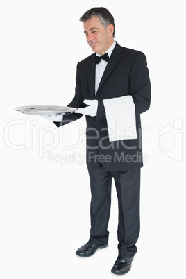 Waiter offering something on tray