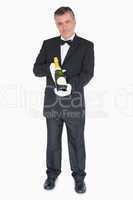 Waiter offering bottle of champagne